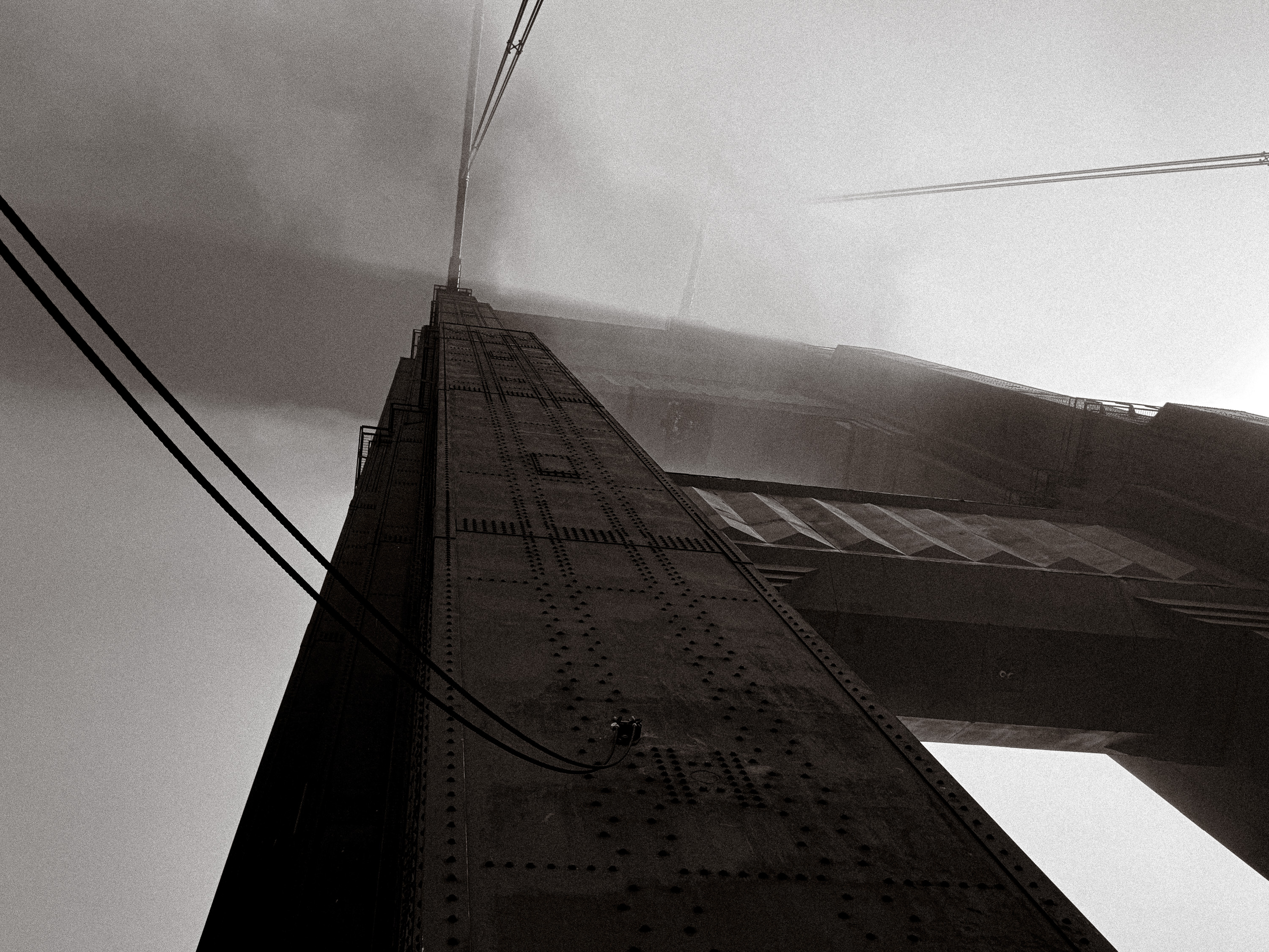 Looking upward into the Golden Gate Bridge in fog